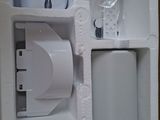 a white box with a speaker and a charger inside of it