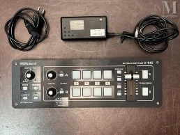 a remote control on a table next to a keyboard