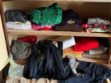 a closet full of clothes and other items in it