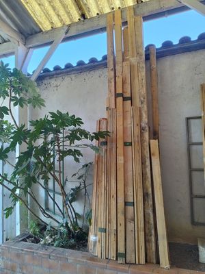 a pile of wood sitting on the side of a building