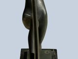 a statue of a woman holding a surfboard on a marble base