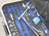 a suitcase with tools inside of it on the floor