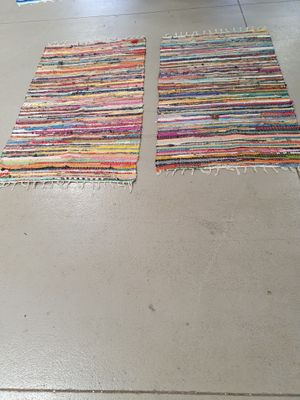 two rugs that are on the floor in the room