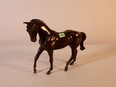a brown horse that is standing on a white surface