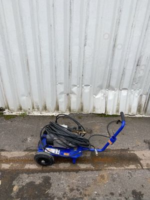 a small blue scooter sitting on the side of the road