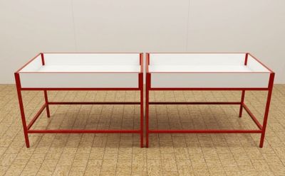 pair of red and white coffee tables with glass tops