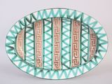 a green and white plate with a design on it