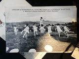 a black and white photo of a group of people playing a game of cricket