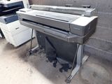 an image of a printer sitting on a stand next to a printer