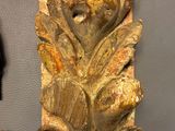 a wooden carving of a bird on the wall