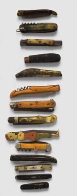 several different types of knives are lined up on a white surface