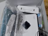 a white box with a laptop inside of it on a wooden table