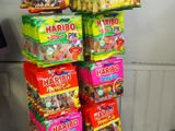 many bags of candy stacked on top of each other
