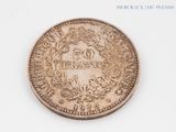 an old coin on a white surface with a picture of a coat of arms on it