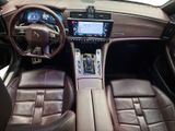 the interior of a luxury car with leather seats and a steering wheel
