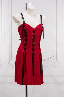 a red dress on a mannequin stand in a room