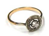 a gold ring with a diamond in the center
