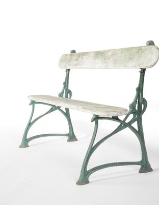 a green bench that is sitting on a white surface