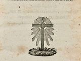 an old book with a cross on top of it sitting on top of a table