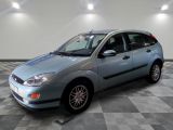 a picture of a blue ford focus parked in a garage