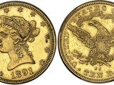 a gold coin with an eagle on the front and a woman ' s head on the back