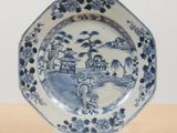 a blue and white plate with a picture on it