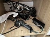 a hair dryer sitting on top of a shelf next to a bunch of wires