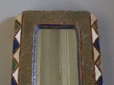 a picture of a mirror that is on the wall