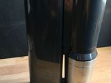 a black coffee maker sitting on a wooden table