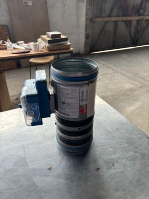 a metal container with a blue lid sitting on top of a table
