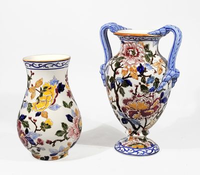 two vases sitting next to each other on a white surface