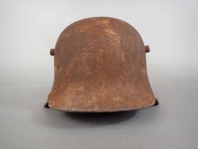 an old helmet is sitting on a table with a white background