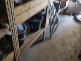 many shelves with pots and pans on them in a room
