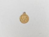 a close up of a gold coin on a white surface