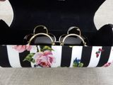 a pair of glasses in a case with a flower design