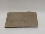 an old book sitting on top of a white table