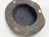 an old stone bowl on a white surface
