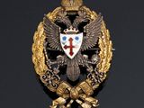 an image of a gold and silver broochle with a cross and two headed eagle