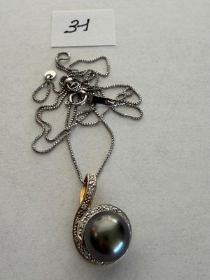 silver and black pearl pendant on a silver chain with a name tag