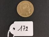 a gold coin with a price tag on it next to a string