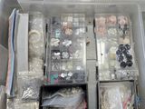 many different types of jewelry in a plastic box