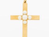 a gold cross pendant with pearls on a white background