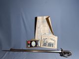 a picture of a sword and some other items on a table