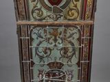 a stained glass window with a coat of arms and a shield on it
