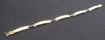 a close up of a bracelet on a black surface