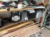 a wooden shelf filled with assorted items in a garage