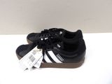black and white adidas sneakers with brown soles on a white surface