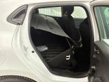 a white car with the door open and a black seat