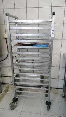 a metal rack with several trays on it in a kitchen