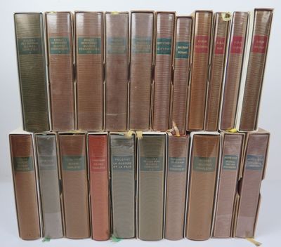 several books are stacked on top of each other on a white surface